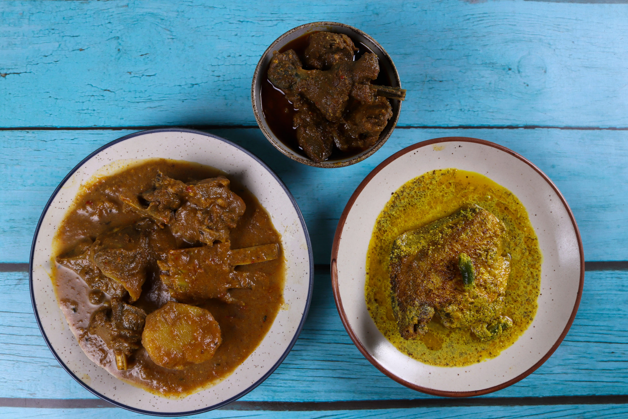 Bangladeshi cuisine including mutton, chicken, and fish curries